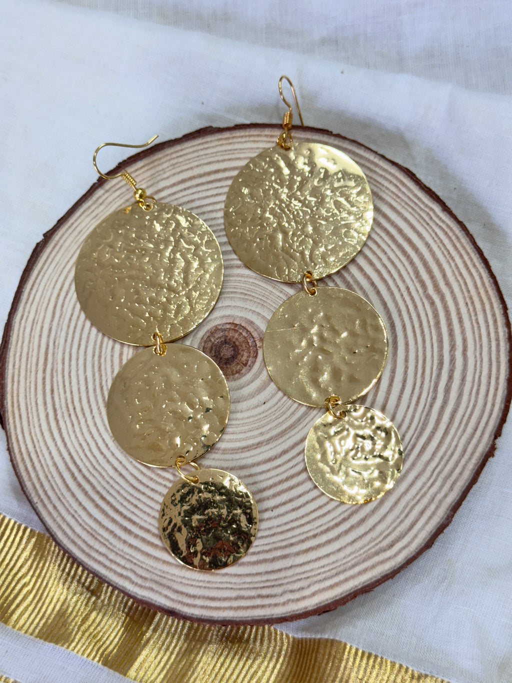 TRIOCOIN - THREE TEXTURED COINS DESCENDING DANGLER EARRINGS